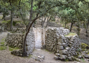 ruined outdoor stone oven amongst trees